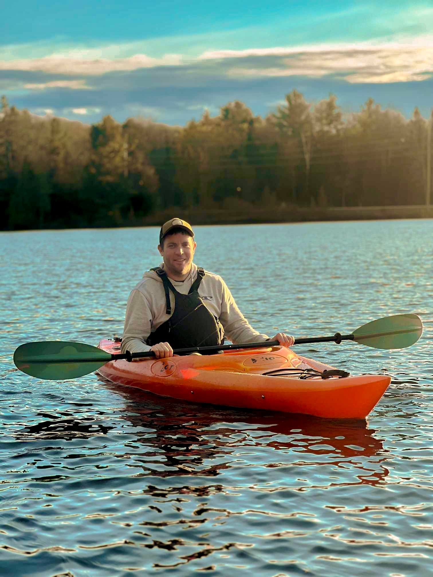 Mike Jefford kayaking on a Muskoka lake at sunset
